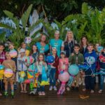A group of children and event organisers with DIY lanterns at the Coral Sea Marina Resort Lantern Parade, Great Barrier Reef Festival 2021