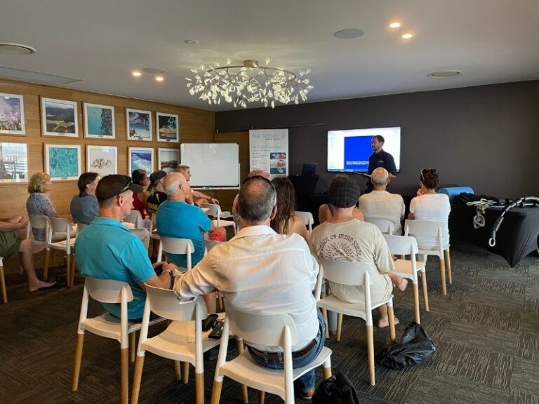 A group of marina guests attending an extreme weather preparedness seminar at the Coral Sea Academy